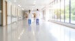 © Hasem-A-Rafsanzani - healthcare professionals walking down hospital corridor