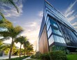 © Colton - modern office building with palm trees and lush greenery