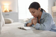 © New Africa - Religion. Woman with Bible praying at home, space for text