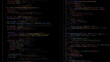 © hiten666 - Colored programming code on a dark screen. Application development and software engineering. Abstract digital background.