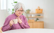 © buritora - Senior woman suffering from chest pain and holding her chest (aspiration, choking, swallowing function)