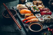 © zhikun sun - Assorted Japanese Sushi and Sashimi Platter with Chopsticks