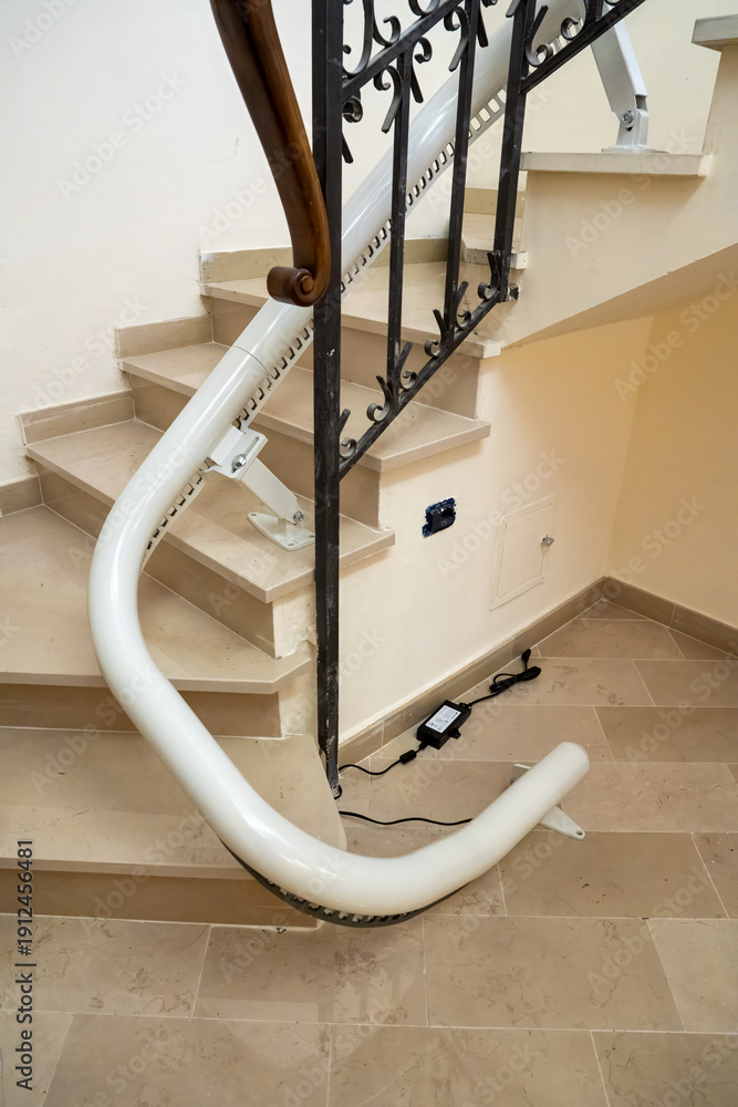 Fotografie Stairlift installation on long curved staircase with custom ...