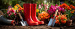© M.Awais Qarni - gardening background with colorful flowers, garden tools, and yellow rain boots on the ground on a sunny day