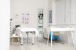 © Pixel-Shot - Interior of massage therapist's office with workplace, couch and shelving unit in modern medical centre