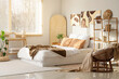 © Pixel-Shot - Interior of bedroom with cozy bed, shelving unit, armchair and pictures on wall