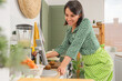 © Pixel-Shot - Young woman with blender using tablet computer in kitchen
