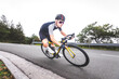 © Jorge Argazkiak - Young caucasian man going downhill on a corner with a road bike on an asphalt road of a mountain.