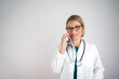© Nenad - Woman physician giving medical advice to patients via telephone, isolated