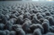 © Maryna - Close-up view of thick gray yarn texture. Woven woolen fibers create a soft, plush surface. Ideal for backgrounds or details in design projects.