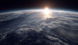 © Sher - a cinematic view of the earth from space, with sunlight shining down on it and clouds in its atmosphere.
