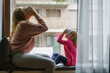 © Igor - mother and daughter relaxing, drinks tea by window on rainy day, Cozy, Home, Lifestyle, Indoor, Relaxation, Comfort