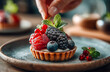 © aboutnuylove - Tartlets with berries and mint on a wooden background. selective focus.