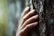 © Chandlerlikes - Man touching tree trunk close up, emotional connection to nature concept