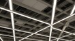 © Fikri - Artistic view of building roof frame installation with long neon light systems that cross each.