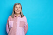 © New Africa - Portrait of beautiful senior woman on light blue background. Space for text