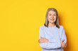 © New Africa - Portrait of beautiful senior woman on yellow background. Space for text