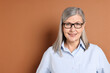 © New Africa - Portrait of beautiful senior woman on brown background. Space for text