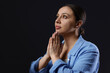© New Africa - Woman praying on black background, space for text