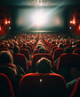 © halcon1 - Audience watching a movie in a cinema with red plush seats and a bright screen illuminating the dark room, creating a cinematic atmosphere