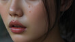 © Rachel - Close up of Asian woman crying with tear and little freckles on her beautiful face.