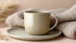 © SashaMagic - Minimalist ceramic coffee cup with saucer on knitted fabric