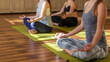 © Maria - young women in yoga class sitting and relaxing making meditation lotus pose