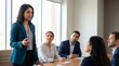© ryker - Confident Indian female leader speaking to diverse team in modern meeting room, professional atmosphere with attentive colleagues and natural light