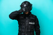 © luismolinero - SWAT caucasian man isolated on blue background covering eyes by hands. Do not want to see something