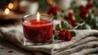 © Suppattra - Burning Red Candle with Flowers on Linen Fabric in Soft Light
