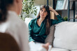 © nenetus - Shot of beautiful woman having therapy while the psychologist takes notes, sitting on the couch in the psychology office