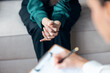 © nenetus - Shot of beautiful woman having therapy while the psychologist takes notes, sitting on the couch in the psychology office