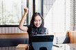 © Tj - Woman celebrating success looking at tablet screen