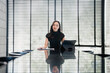 © Tj - Asian businesswoman leading meeting in modern conference room