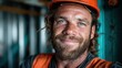 © Freshpixel - A close-up portrait of a construction worker wearing an orange hard hat, showcasing his friendly smile and blue eyes, highlighting the spirit of hard work and dedication.