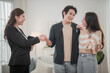 © surachetkhamsuk - Happy Asian family young couple in love hand holding keys when they are buying real estate for new home.