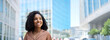 © insta_photos - Happy confident smiling young African American professional woman, student, female entrepreneur businesswoman manager looking away standing outdoors on business city street dreaming of career success.