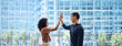 © insta_photos - Happy diverse young team business people, two colleagues man and woman employees giving high five standing in office as concept of corporate success, leadership in teamwork, professional achievement.