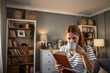 © Migma_Agency - Woman enjoying leisure time reading book and drinking coffee