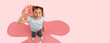 © Prostock-studio - A young girl stands in a bright space with a large pink design on the floor. She smiles widely and shows an OK hand gesture. The scene captures her joy and playful spirit.