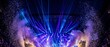 © Aneela - A vibrant concert stage with blue and purple laser lights and pyrotechnics at night