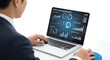 © NOR ALAM - Businessman analyzing data on laptop with futuristic interface