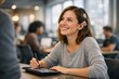 © Natallia Simanchyk - A young woman with a cochlear implant smiles while using a digital tablet and stylus. The setting is a bright modern office, conveying inclusion and positivity. Ideal for health and technology.
