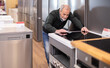 © JackF - Elderly man buyer chooses electric stove in home appliance store