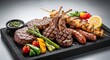 © shofikul - Sizzling grilled meats and vegetables served on a black stone slab with herbs and lemon