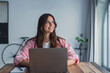© Daniel - A young woman sits at her desk at home distracted from work, staring into the distance as she imagines new possibilities and enjoys a peaceful moment of reflection