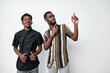 © SHOTPRIME STUDIO - Two african men with dark skin posing and smiling on white background. Casual clothing, standing close, happy expression and relaxed mood in studio photo.
