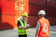 © Wanwajee - Logistics supervisors coordinating cargo inspection at container yard while reviewing documentation and communicating via radio. Supply chain management concept.