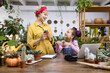 © sofiko14 - A mother and daughter share a moment while surrounded by plants in a bright and inviting shop