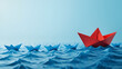 © Breanna - Red boat origami leading a group of blue boats origami leadership concept